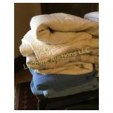 stack of queen comforters and old quilt