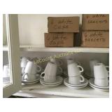 many white coffee cups and saucers some new