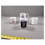 Four Decorative Mugs with Various Designs