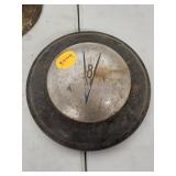 Vintage Ford V8 Hubcap with Visible Wear