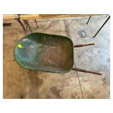 Green Metal Wheelbarrow with Rusted Bottom and Woo