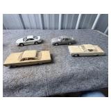 Four Plastic Model Vehicles in Assorted Styles and