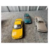Three Plastic Model Cars in Various Colors