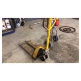 Narrow base pallet jack.