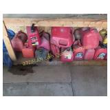 group of gas cans, most missing tops