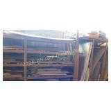 Wall of scrap wood, back stock, can take shelving