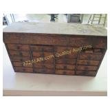 small wooden box with drawers, has oil on it