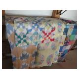 group of quilts and quilt tops