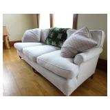 White 6ft Sofa with Throw Pillows and Blanket