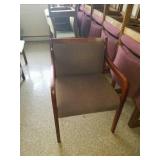 1 tan cushioned/dark wood chair.