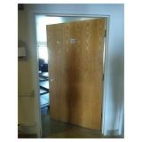 Steele door frame with wood door and hardware.