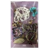 Container of assorted jewelry