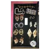 Flat of mostly earrings. Container not included.