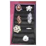 6 rings 1 pendant. Container not included.