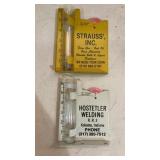 2 advertising rain gauges. Both are metal.