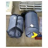 2 rolled up sleeping bags in carrying bags.