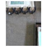 Cute black metal horseshoe wall deco/hooks.