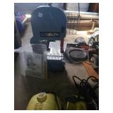 Delta band saw with book and extra blade. In