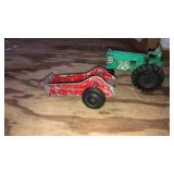 2 old toys. Red metal baler marked Hubley. Green