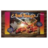 4 plastic fire trucks in box