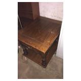 Wooden end table with scratches and small storage