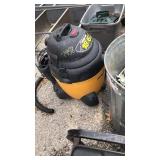 Shop vac with hose and metal shelf