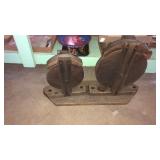2 wood pulleys on a frame. Cool piece of decor