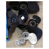Group of 4 boat propellers various sizes.