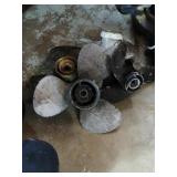 Group of 4 boat propellers various sizes.
