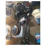 Lots of golf clubs, 2 bags, and pairs of shoes sz