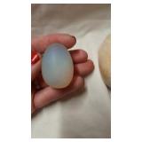 Two stone eggs. Small one has a blue tint to look