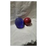 Two round stone paperweights.