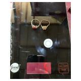 Two 10 karat gold rings one with red stone, stone