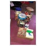 3 glass jars and a box of assorted matchboxes.