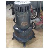 Vintage kerosene heater that features a viewing