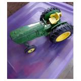 Green metal tractor with no markings 9 in by 5 in