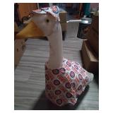 You get a 2 ft tall plastic goose with 3 outfits