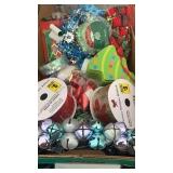 Box of Christmas ribbon, cards, bags, tins, and