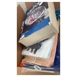 Box of rugs, laundry bags, blankets and material.