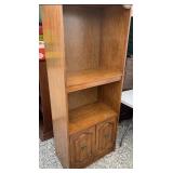 Nice tall shelf with enclosed storage on bottom.