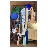 Box of tools.  Paint brushes, hammer, extension
