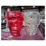 2 skull cups one plastic one glass