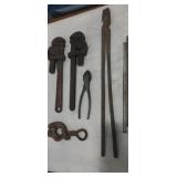 2- stillson wrenches,  forge tongs , wire cutters