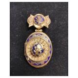 Gold and blue tone locket brooch marked Lisner