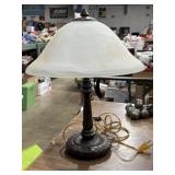 Solid metal table lamp with a frosted glass shade