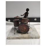 Metal drummer sculpture on marble base. Drummer