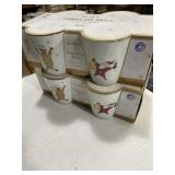 Two sets of four porcelain 10 ounce can Christmas