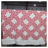 Old handmade red and white ocean waves quilt