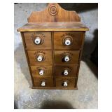 wooden spice cabinet with eight drawers and