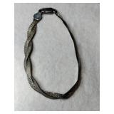 Silver braided bracelet marked 925.     .215oz